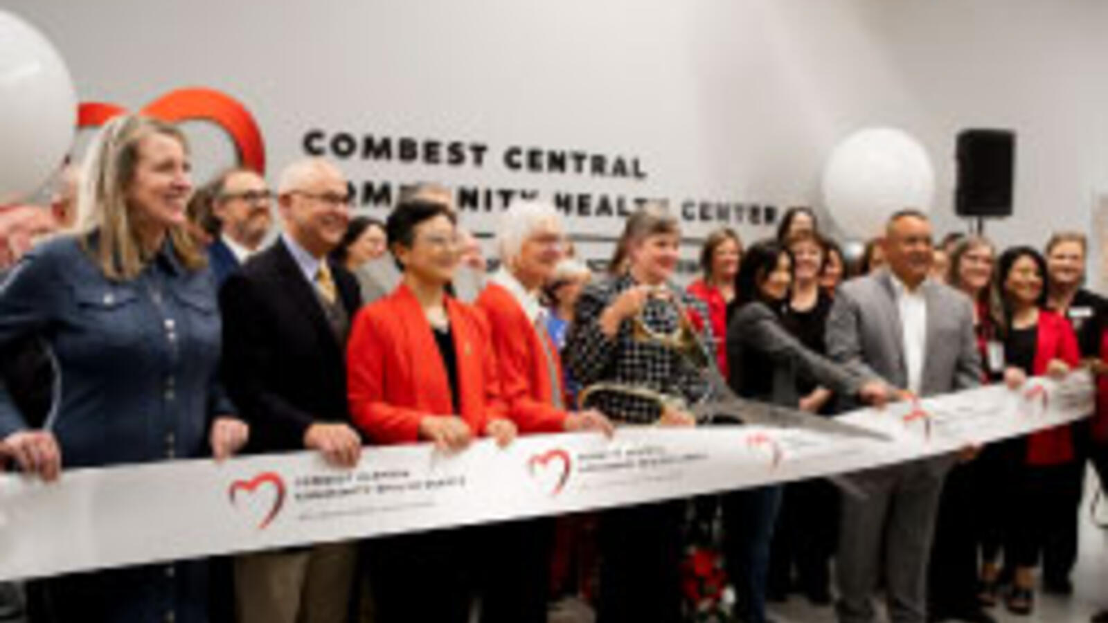 Large group of TTUHSC administrators cuts a ribbon.