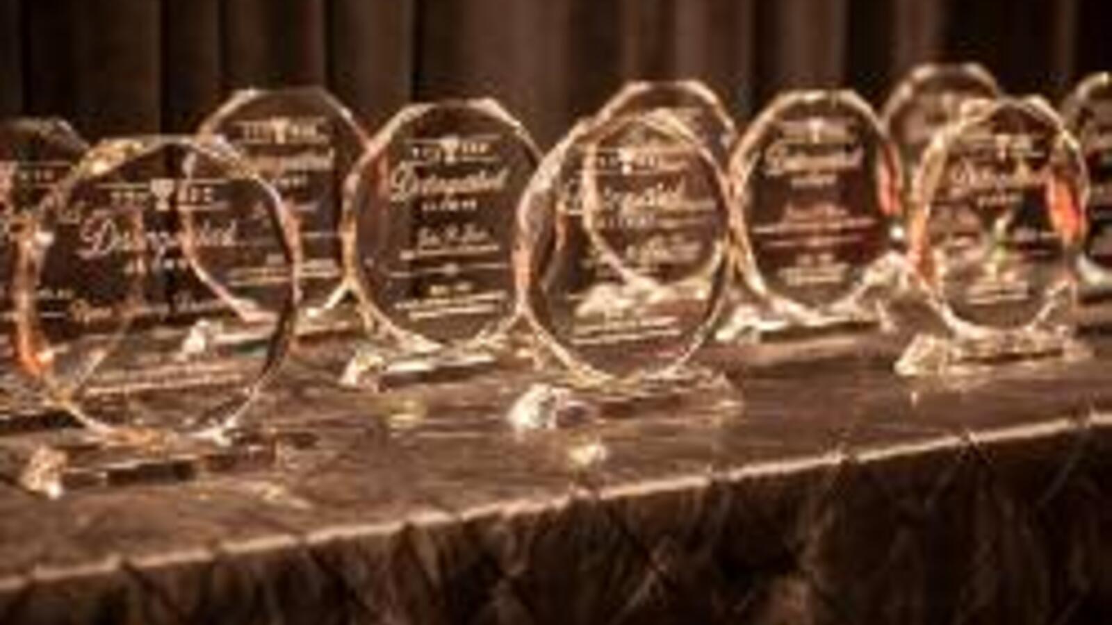 Distinguished Alumni Award plaques on a table