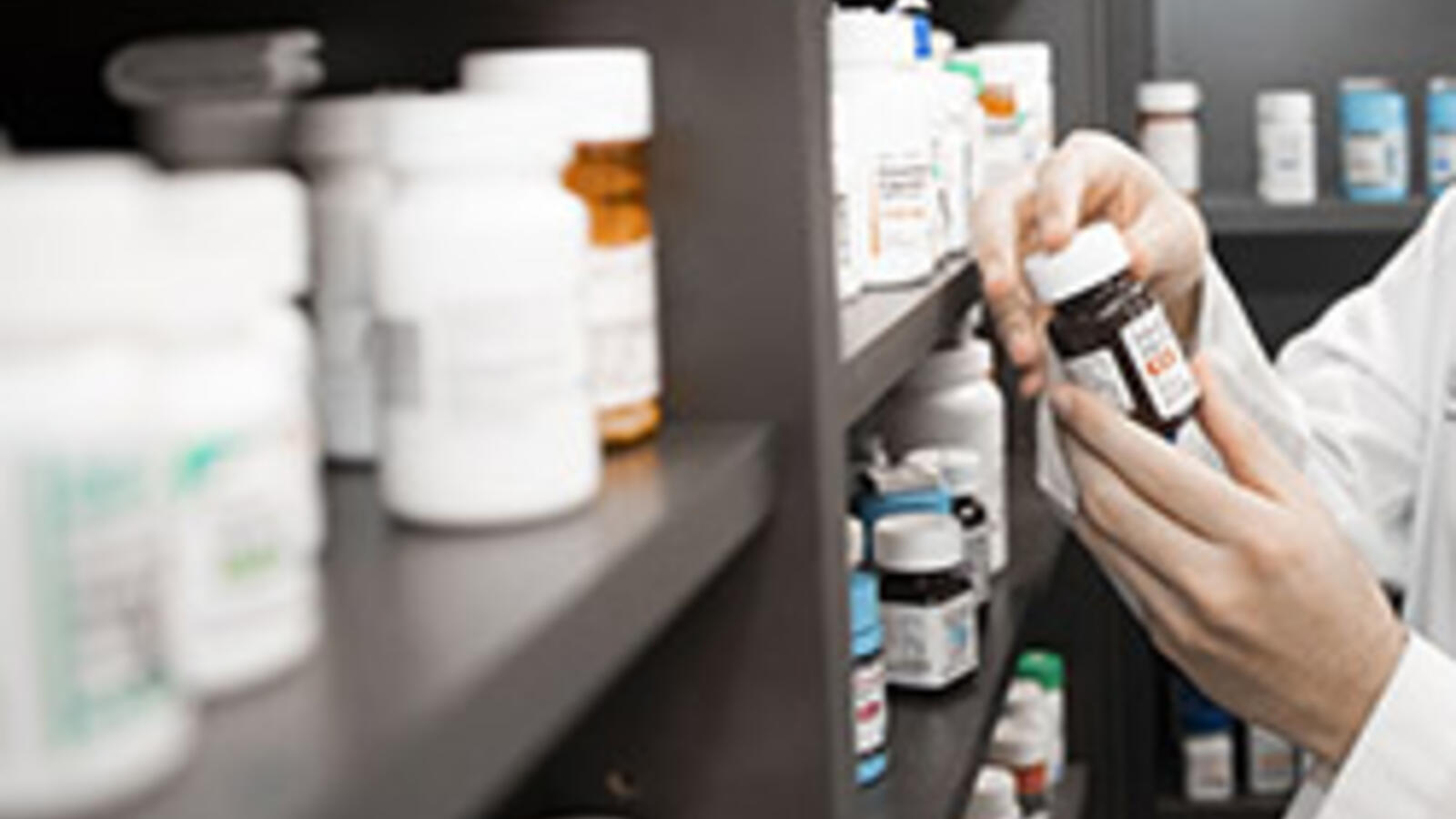 Pharmacist Checking a prescription bottle