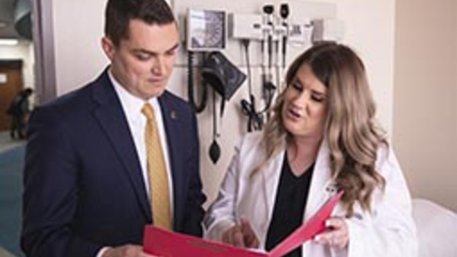 two health care professionals looking at a file