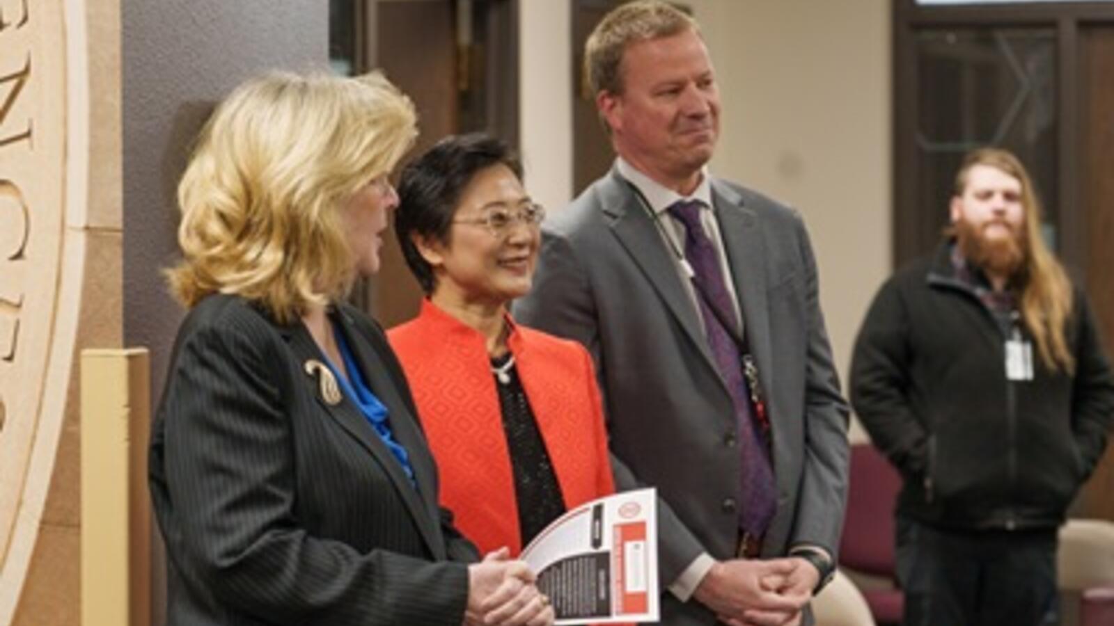 three people smiling for a picture