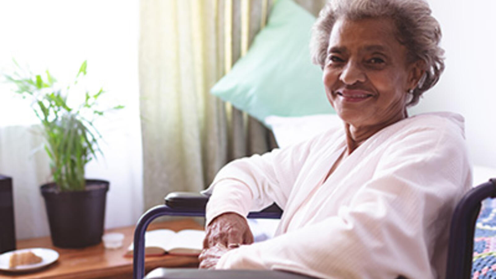 senior woman in wheelchair by a window