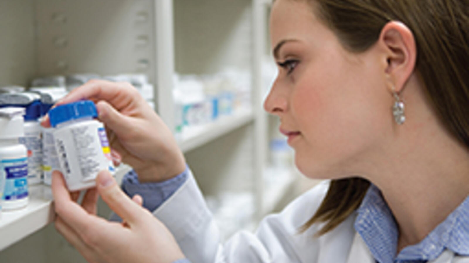 TTUHSC pharmacy student reviewing a bottle label.