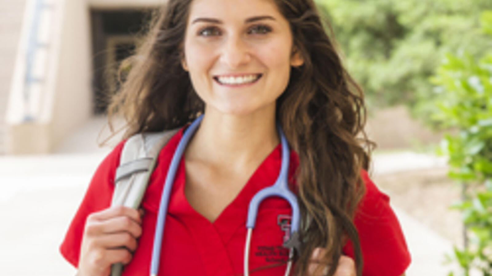 TTUHSC Nursing Student standing outdoors with backpack.