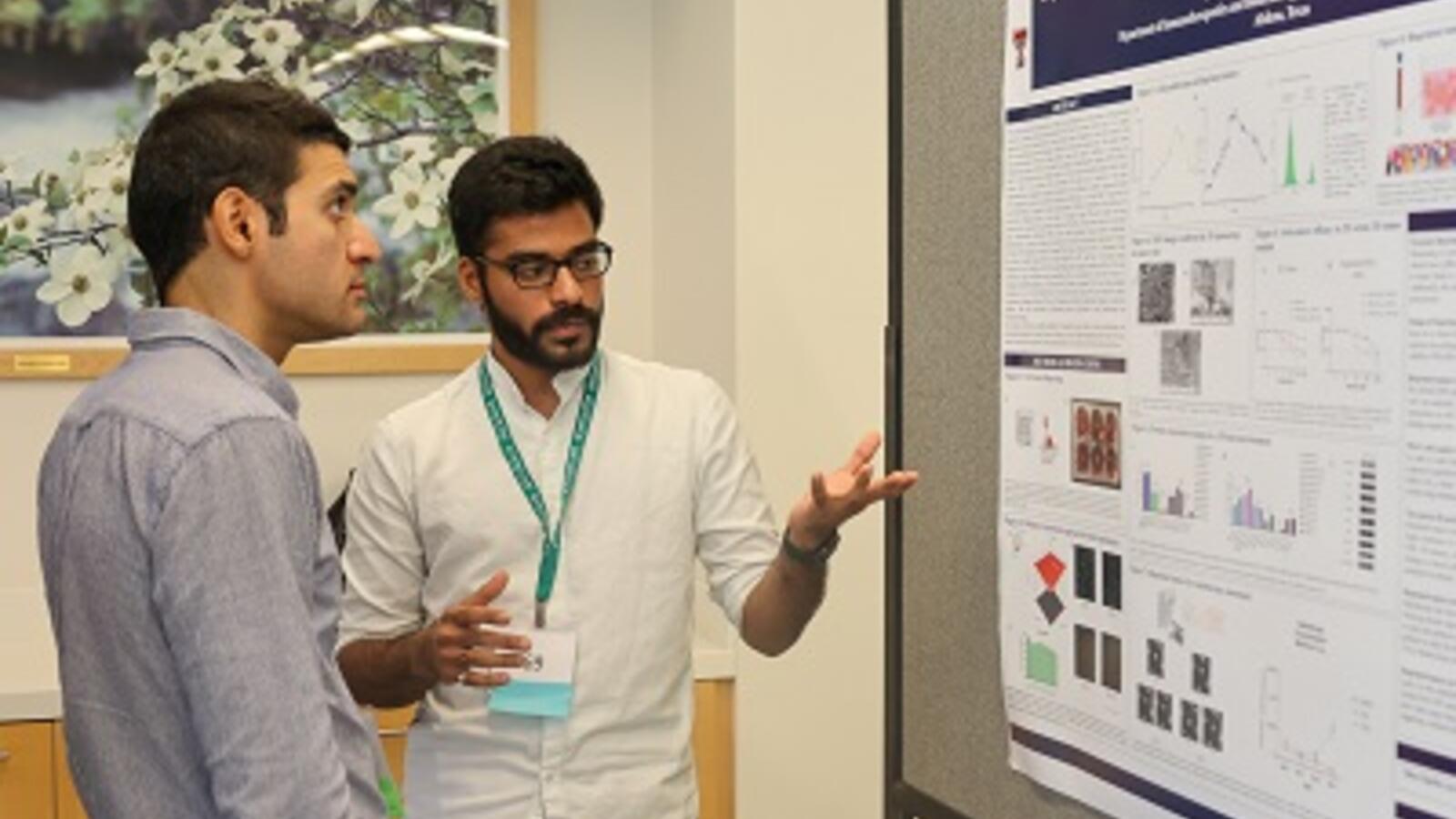 Shreyas Gaikwad, a Ph.D. candidate, with a presentation board for his studies