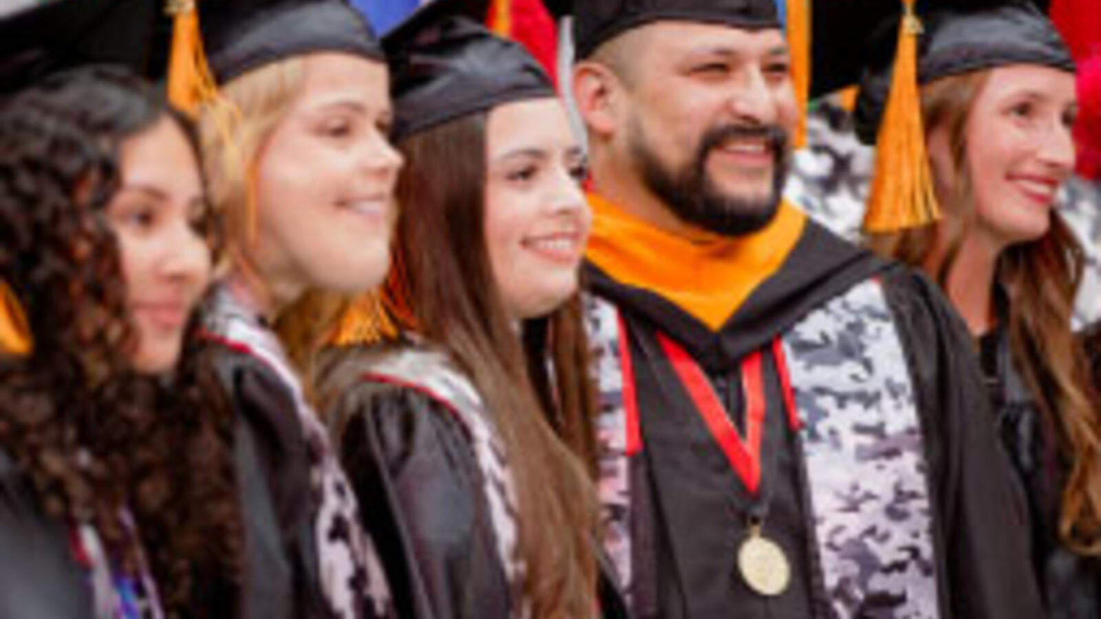 Several TTUHSC VBSN graduates stand together at commencement.