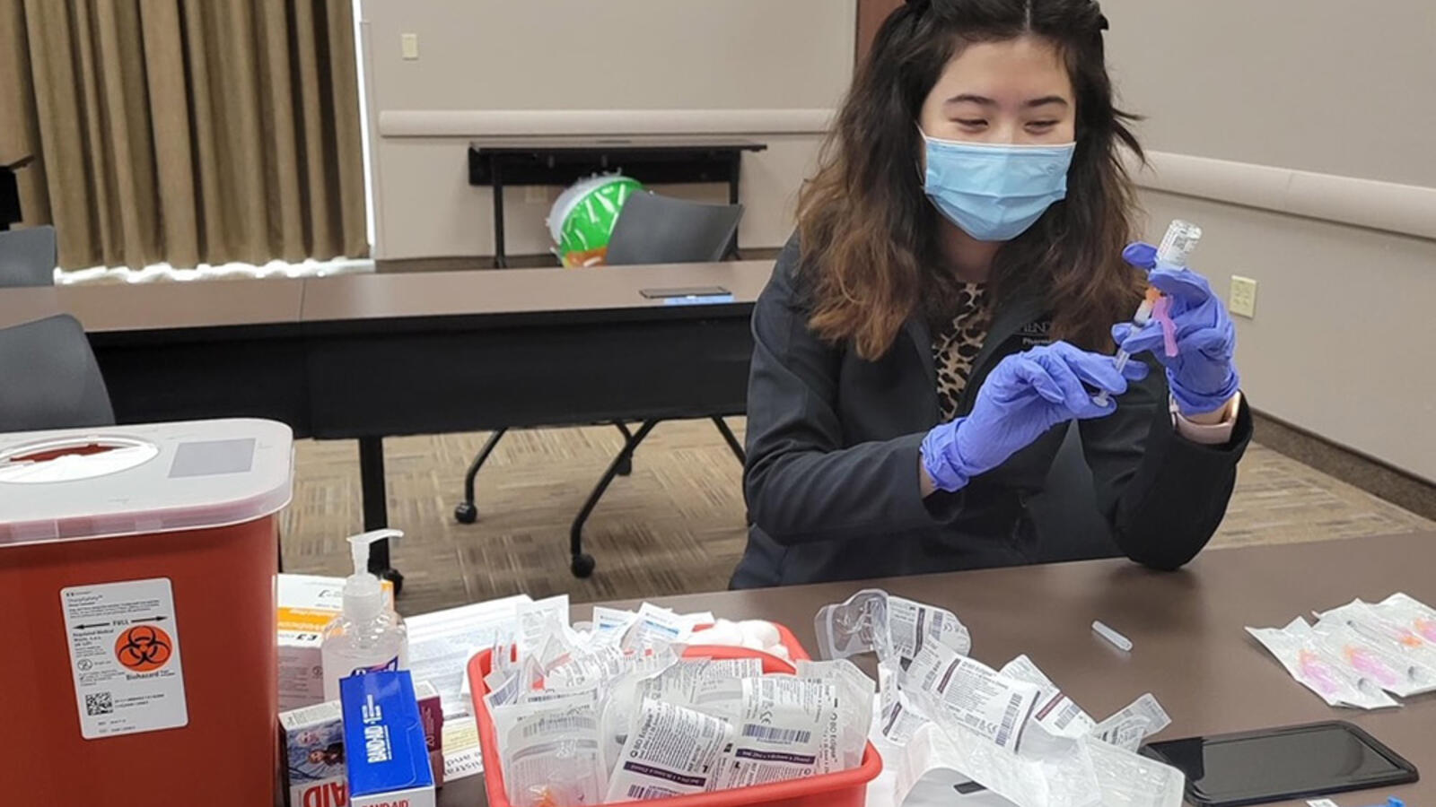 woman preparing COVID-19 vaccine