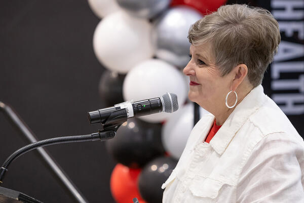 President Rice-Spearman smiling behind a podium at an employee recognition event.