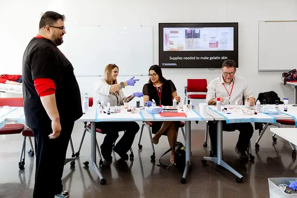 Healthcare simulation workshop participants creating training materials in a classroom setting