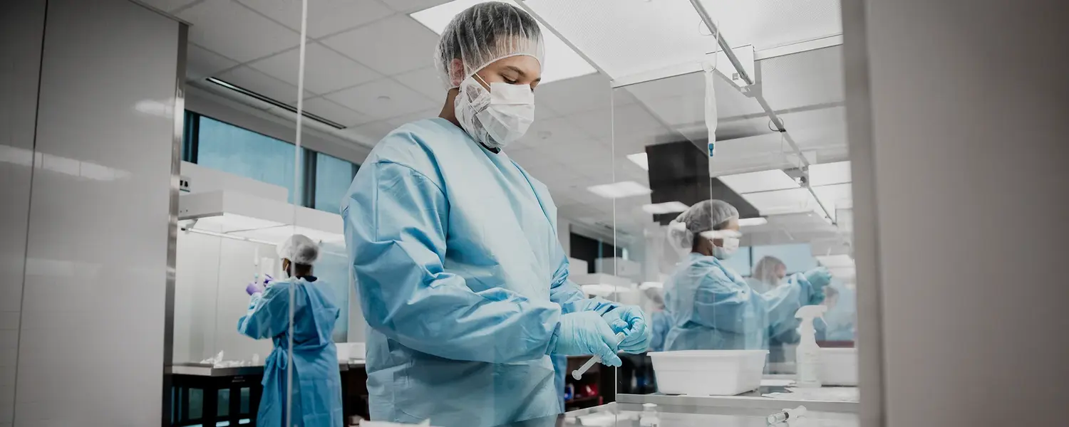 Healthcare student in protective equipment working in a clinical laboratory