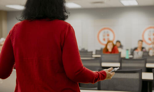 Professor stands at the front of a classroom addressing TTUHSC students.