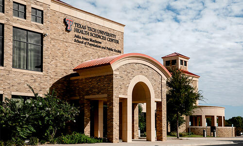 Exterior view of the Texas Tech University Health Sciences Center building in Abilene, featuring a brick entrance and landscaped grounds.