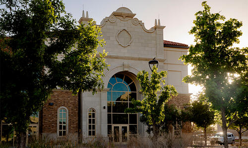 Exterior view of the Texas Tech University Health Sciences Center building in Odessa, featuring a stone and brick facade.