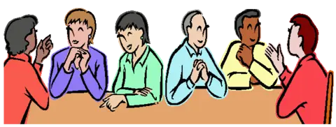 People wearing colorful shits sitting around a brown table.