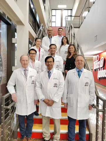 A group of gastroenterology medical professionals posing together on a staircase inside a Texas Tech University Health Sciences Center building.