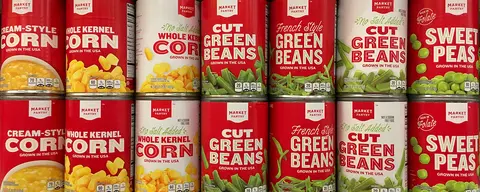 Rows of canned corn, green beans and sweet peas.