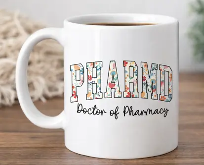 White coffee mug featuring the words “PharmD, Doctor of Pharmacy” in a colorful design.