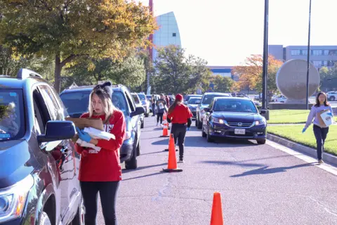 School of Pharmacy volunteers collect unused medications from drivers during a community Medication Cleanout event.
