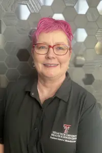 terri headshot in front of tiled wall