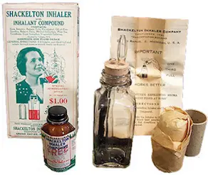 Vintage Shackleton inhaler packaging displayed with a glass inhaler bottle, medicine bottle, instruction leaflet and inhalation mask.