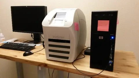 Aperio ScanScope digital slide scanner with computer monitor and desktop workstation.