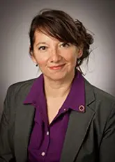 Headshot of Rosalinda R. Jimenez wearing a gray blazer over a purple collared shirt, smiling at the camera.