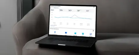 Laptop displaying a website analytics dashboard with a line graph.