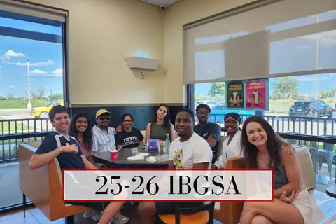 IBGSA students gather around a table in a restaurant.
