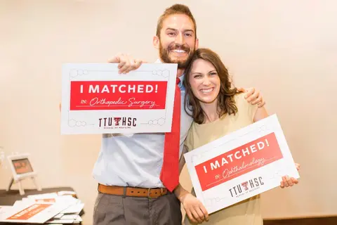 Two medical students celebrate matching into orthopedic surgery and ophthalmology.
