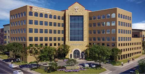 Exterior rendering of the Texas Tech University Health Sciences Center building with a central glass entrance and landscaped grounds.