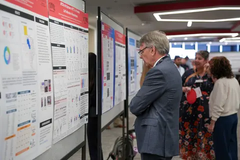 CPRIT Chief Scientific Officer Dr. Scott W. Hiebert reviewing posters