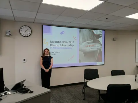 TTUHSC Daily Dose Summer Research Internship Williams next to presentation