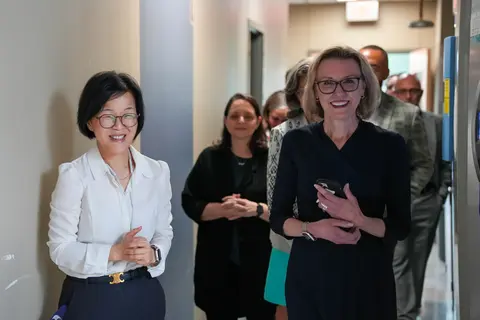 CPRIT Kand Lab tour with people walking down the hallway together.