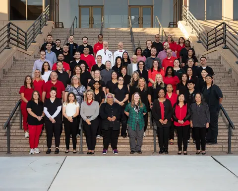 Group photo of Lubbock Dept. of Family Medicine faculty and staff gathered on and around a staircase outside the TTUHSC Lubbock facility.