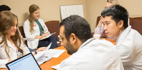 Group of medical students study together.