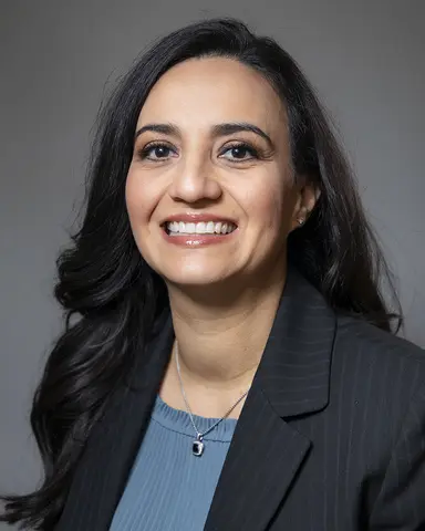 Sonya Castro-Quirino, D.Bioethics, MBA, wears a jacket and smiles.