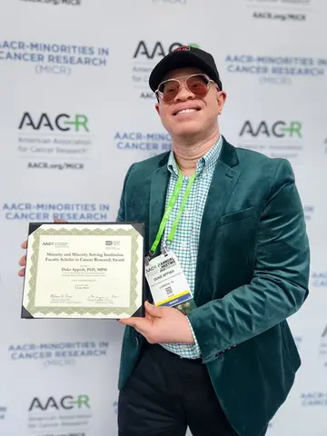 man holding award certificate