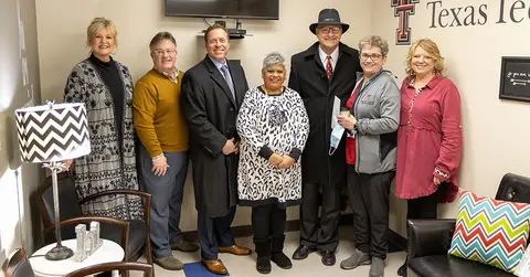 Lubbock national bank team for CARE donation standing in a line