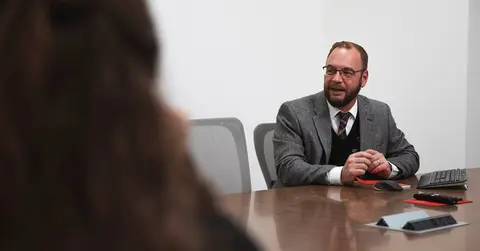 Zach Sneed, Ph.D. talking at a conference table