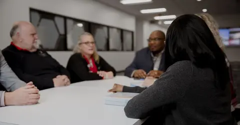 health care professionals talking at a table