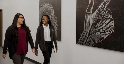 two women walking down the hall at TTUHSC