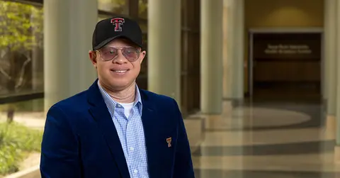 Duke Appiah, Ph.D., standing in the hallway at TTUHSC