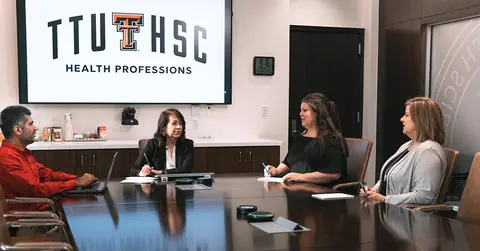health care professionals sitting at a table