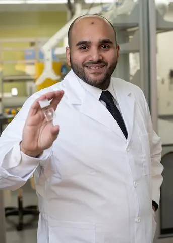 man in white coat holding bio-printed model