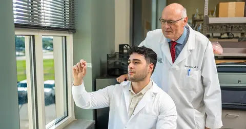 two doctors in white coats in a lab