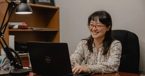 health care professional working on a laptop
