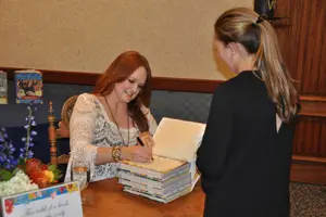 Drummond signed books after the Power of the Purse luncheon.