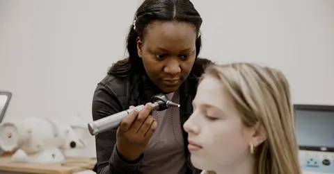 doctor looking in a patient's ear