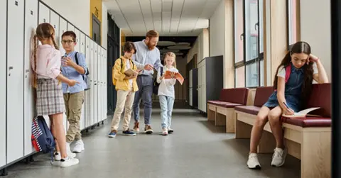 children and school professionals in a school hallway