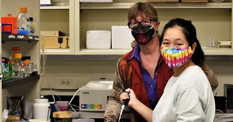 Ina Urbatsch, Ph.D., with a student in a lab setting